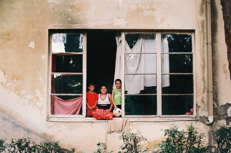 Three children in a weathered window, photographed for Georgia Stories